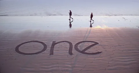 The word one drawn on a beach Stock Footage 58649678