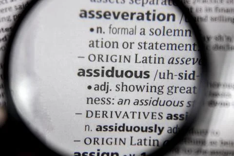 The word or phrase assiduous in a dictionary. Stock Photos