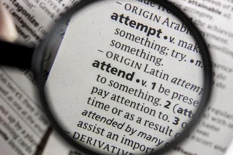 The word or phrase attend in a dictionary. Stock Photos
