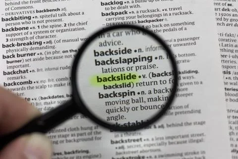 The word or phrase backslide in a dictionary. Fotos Stock