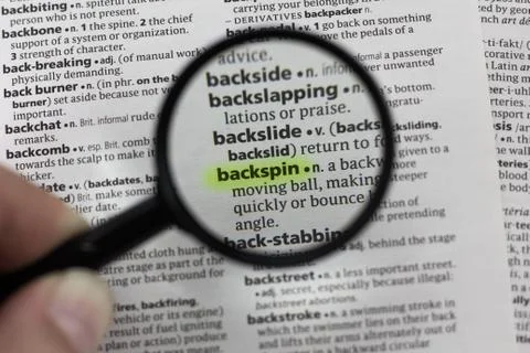 The word or phrase backspin in a dictionary. Stock Photos