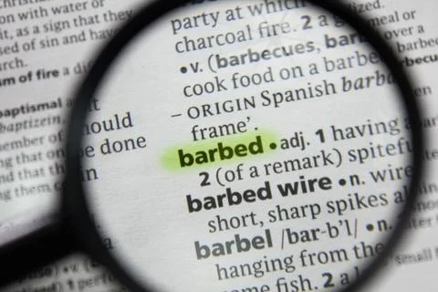 The word or phrase barbed in a dictionary. Stock Photos