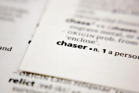 Word or phrase chaser in a dictionary. Stock Photos
