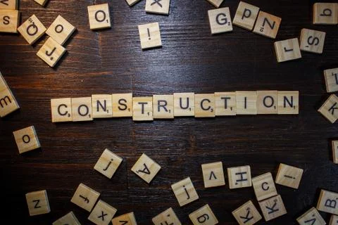Word or phrase Construction made with scrabble letters. Stock Photos