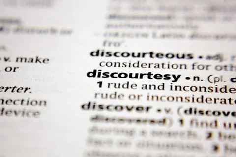 Word or phrase discourtesy in a dictionary. Stock Photos
