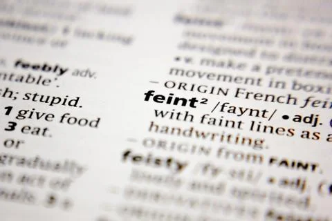 Word or phrase feint in a dictionary. Stock Photos