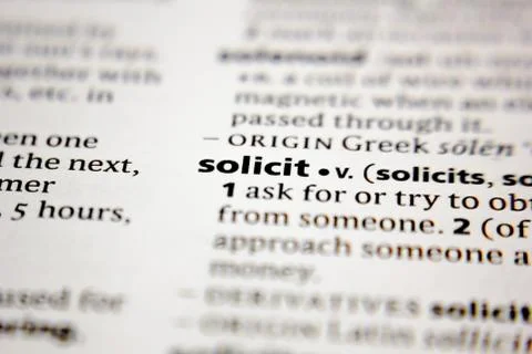 Word or phrase solicit in a dictionary. Stock Photos