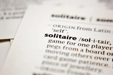 Word or phrase solitaire in a dictionary. Stock Photos