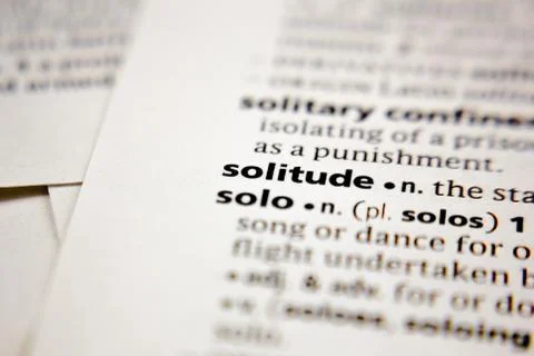 Word or phrase solitude in a dictionary. Stock Photos