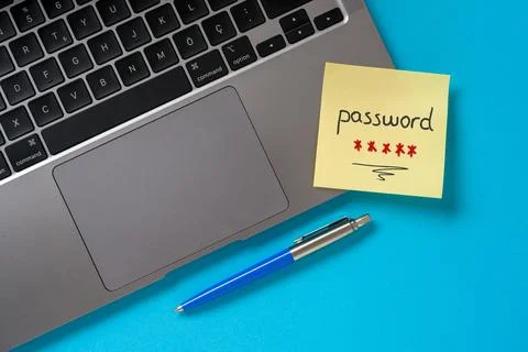 The word password written on a sticky note paper on modern laptop Stock Photos