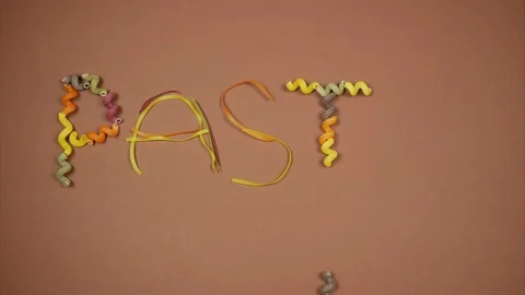 Word pasta made of colored macaroni. Stop motion animation Stock Footage 89882248