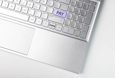 Word PAY on enter button on laptops keyboard. Online payment concept Stock Photos