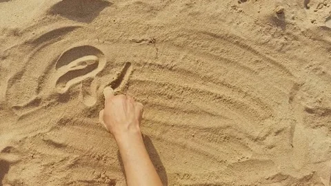 Word peace and shape of heart on sand written by female hand. Concept of peace Stock Footage 203959863