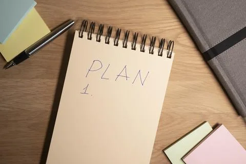 Word plan on sheet of planner or notebook. Business and financial goals conce Stock Photos