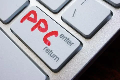 Word PPC (pay per click) written on a keyboard. Stock Photos