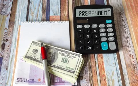 The word PREPAYMENT on a calculator, next to euros and dollars. Business and  Stock Photos