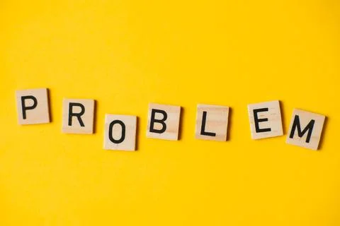 Word problem on a yellow background. The concept of difficulties. Stock Photos