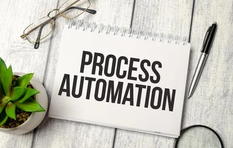 Word process automation on notepad and wooden background Stock Photos