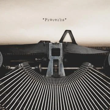 Word of " Proverbs " on Antique typewriter with aged textured paper sheet. Stock Photos