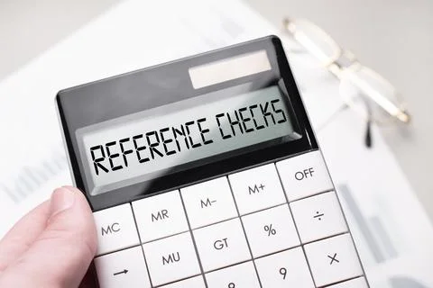 The word REFERENCE CHECKS is written on the calculator. Business man holding  Stock Photos