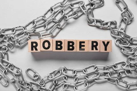 Word ROBBERY with chains on light background Stock Photos
