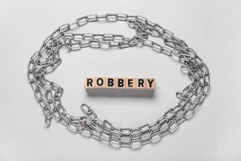 Word ROBBERY with chains on light background Stock Photos