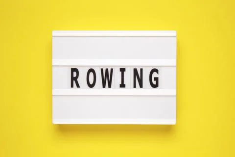 The word rowing on lightbox isolated yellow background. Photos