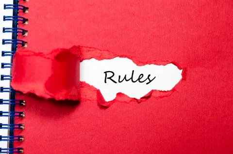 The word rules appearing behind torn paper Stock Photos