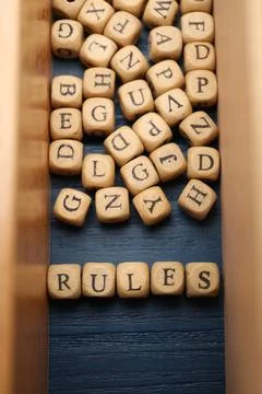 Word Rules made of cubes with letters on blue wooden table, flat lay Stock Photos