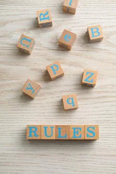 Word Rules made of cubes with letters on light wooden table, flat lay 写真素材