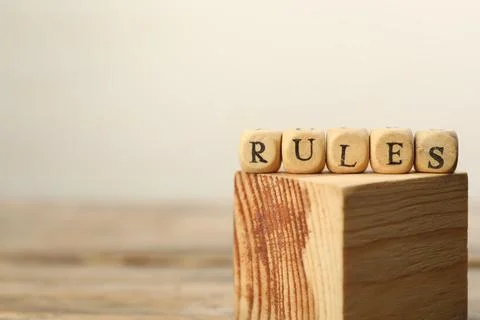 Word Rules made of cubes with letters on wooden block, space for text Foto stock