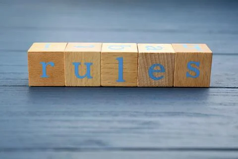 Word Rules made of cubes with letters on light blue wooden table Stock Photos