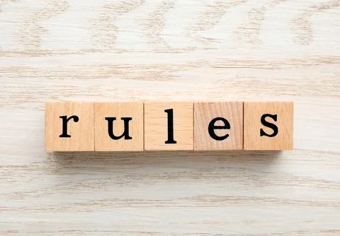 Word Rules made of cubes with letters on light wooden table, top view Stock Photos