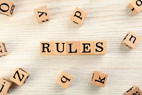 Word Rules made of cubes with letters on light wooden table, flat lay Stock Photos