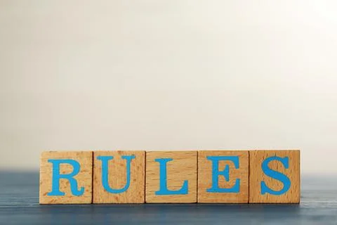 Word Rules made of cubes with letters on light blue wooden table Stock Photos