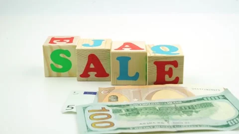 The word sale made of cubes. Dollar and Euro banknotes falling to the foreground Stock Footage 149136341