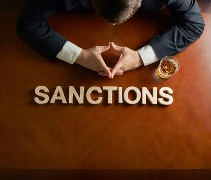Word Sanctions and devastated man composition Stock Photos