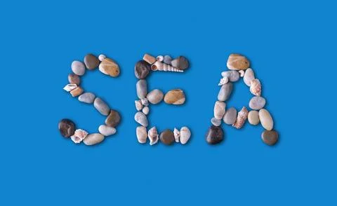 The word "SEA" is lined with shells and stones of different shapes and colo.. Stock Photos