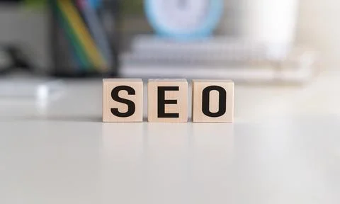 The word seo (search engine optimization) written on wooden blocks with com.. Stock Photos