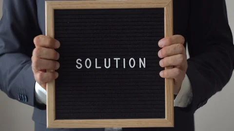 Word Solution from Letters on Text Board in Anonymous Businessman Hands Stock Footage 91397947
