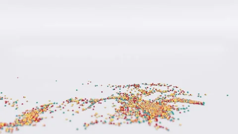 The word sprinkles exploding into tiny sprinkles on a white background Stock Footage 142026745