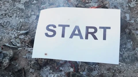 Word Start on a white sheet of paper burns into a fire against. Slow motion Vídeo Stock 138653960