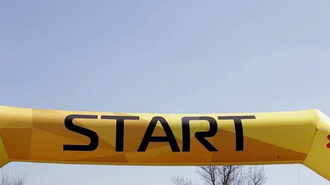 Word Start on a yellow inflatable banner against a blue sky. Stock Footage 110795258