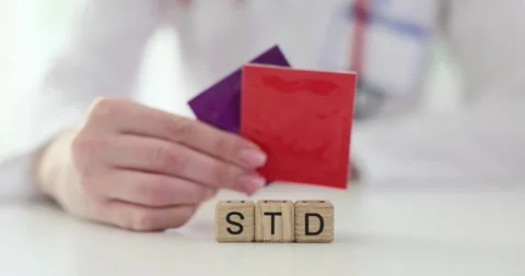 Word STD from wooden cubes against doctor at workplace Stock Footage 280082880