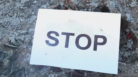 Word Stop on a white sheet of paper burns into a fire against. Slow motion Vídeo Stock 143084281
