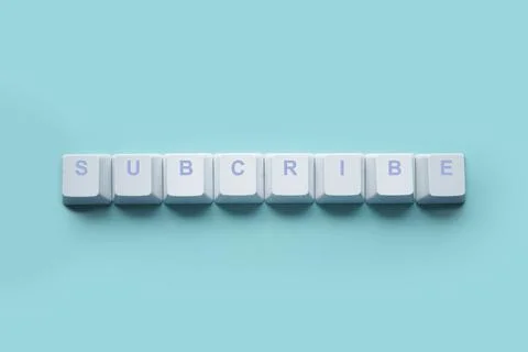 Word SUBCRIBE written on computer keyboard keys isolated on a turquoise Foto stock
