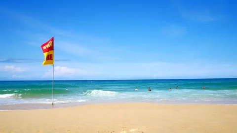 A word Swin Here on the red and yellow flags on the beach.To tell the point s 動画素材 79868666