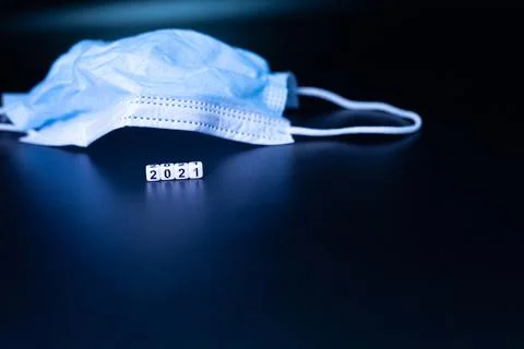 A word on the table from letter cubes, 2021 Medical Mask. Stock Photos