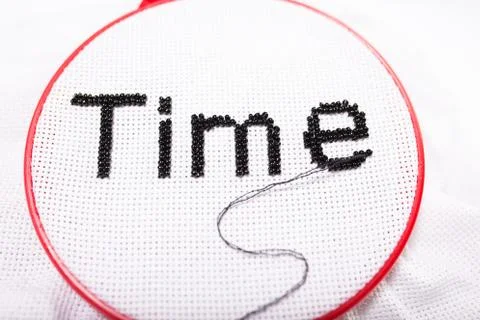 Word time. Time concept with thread and beads. Stock-Fotos
