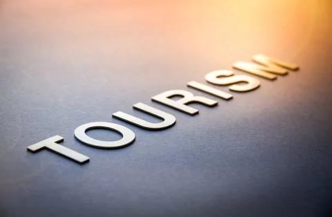 Word tourism written with white solid letters Stock Photos